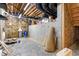 Unfinished basement with exposed beams and concrete walls at 6366 Lineberry Rd, Liberty, NC 27298
