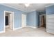 Blue bedroom with carpet, built-in shelves, and ensuite bath at 6366 Lineberry Rd, Liberty, NC 27298