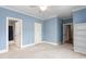 Spacious bedroom featuring three entry doors, carpet and ample lighting at 6366 Lineberry Rd, Liberty, NC 27298