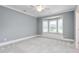 This empty bedroom features a bay window seat and neutral carpet at 6366 Lineberry Rd, Liberty, NC 27298
