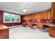 A large bonus room features built-in cabinets, desks, and a ceiling fan at 6366 Lineberry Rd, Liberty, NC 27298