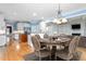 Elegant dining room with an oval table, chandelier, and hardwood floors adjacent to a modern kitchen at 6366 Lineberry Rd, Liberty, NC 27298