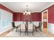 Formal dining room with wainscoting, chandelier, and hardwood floors, perfect for entertaining at 6366 Lineberry Rd, Liberty, NC 27298