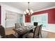 Dining room with decorative chandelier, hardwood floors, and large windows, a great place to gather at 6366 Lineberry Rd, Liberty, NC 27298