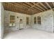 Covered patio area showcasing brick pillars, natural light, access door and views of the backyard at 6366 Lineberry Rd, Liberty, NC 27298