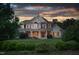 Brick two-story house with a large front porch and manicured lawn at 6366 Lineberry Rd, Liberty, NC 27298