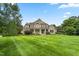 House exterior showcasing a spacious lawn and landscaping at 6366 Lineberry Rd, Liberty, NC 27298