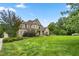 House exterior showcasing a spacious lawn and landscaping at 6366 Lineberry Rd, Liberty, NC 27298