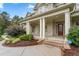 Brick front porch with columns and a red front door at 6366 Lineberry Rd, Liberty, NC 27298