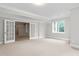 Spacious living room with neutral paint, carpet, trim and bright window with tree view at 6366 Lineberry Rd, Liberty, NC 27298