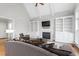 Cozy living room with vaulted ceiling, fireplace, built-in shelves and a comfortable sofa with decorative pillows at 6366 Lineberry Rd, Liberty, NC 27298