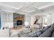 Bright living room with stone fireplace, custom built-ins, hardwood floors, and coffered ceilings at 6366 Lineberry Rd, Liberty, NC 27298