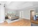 Main bedroom with tray ceilings, hardwood floors, ceiling fan, and an ensuite bathroom for optimal comfort at 6366 Lineberry Rd, Liberty, NC 27298