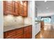 Butler's pantry with granite countertops, wood cabinets, and convenient access to the kitchen at 6366 Lineberry Rd, Liberty, NC 27298