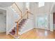 Elegant staircase with a red carpet runner and hardwood floors at 6366 Lineberry Rd, Liberty, NC 27298