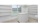 A walk-in closet features built-in shelving and a center island for storage at 6366 Lineberry Rd, Liberty, NC 27298