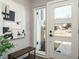 Bright and airy entryway with a large door and modern light fixture at 1531 Urban Trace Ln, Raleigh, NC 27608