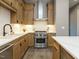 Modern kitchen with stainless steel appliances and light wood cabinets at 1531 Urban Trace Ln, Raleigh, NC 27608