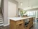 Kitchen island with quartz countertop and built-in microwave at 1531 Urban Trace Ln, Raleigh, NC 27608