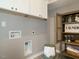 Well-equipped laundry room with cabinets and shelving at 1531 Urban Trace Ln, Raleigh, NC 27608