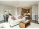 Open living room features a comfy sofa, a fireplace, and sliding glass doors leading to a balcony at 1531 Urban Trace Ln, Raleigh, NC 27608