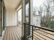 Spacious balcony features wood-style floors, black metal railings and neighborhood views at 1533 Urban Trace Ln, Raleigh, NC 27608