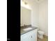 Bathroom with gray countertop, white cabinets, gold fixtures, and a mirror at 1533 Urban Trace Ln, Raleigh, NC 27608