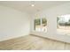 Bright bedroom featuring hardwood floors, large windows and neutral tones at 1533 Urban Trace Ln, Raleigh, NC 27608