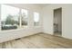 Bright bedroom with light hardwood floors and large windows offering view of the house next door at 1533 Urban Trace Ln, Raleigh, NC 27608