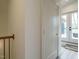 Bright hallway features hardwood floors and a closet, leading to a door with glass panels at 1533 Urban Trace Ln, Raleigh, NC 27608