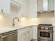 Modern kitchen featuring stainless steel appliances, white cabinets, and a stylish faucet at 1533 Urban Trace Ln, Raleigh, NC 27608