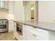 Modern kitchen with white cabinets, stainless steel appliances, and light hardwood floors at 1533 Urban Trace Ln, Raleigh, NC 27608