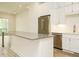 Bright kitchen with stainless steel appliances, white cabinetry, and island with stone countertop at 1533 Urban Trace Ln, Raleigh, NC 27608
