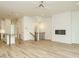 Open-concept living room with fireplace and view of kitchen and stairs with hardwood floors at 1533 Urban Trace Ln, Raleigh, NC 27608