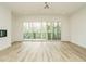Open living room with a fireplace and large windows at 1533 Urban Trace Ln, Raleigh, NC 27608