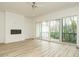 Spacious living room with hardwood floors, fireplace, and large sliding doors to a balcony at 1533 Urban Trace Ln, Raleigh, NC 27608