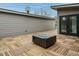 Stylish outdoor patio features a modern fire pit and wood-patterned tile flooring at 1533 Urban Trace Ln, Raleigh, NC 27608