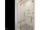 New marble tiled shower features a glass door, a built-in bench and corner shelving at 1533 Urban Trace Ln, Raleigh, NC 27608