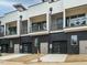 Modern black and white townhomes feature balconies, garages and updated exterior at 1533 Urban Trace Ln, Raleigh, NC 27608