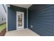 The backyard patio is a great place to relax with its concrete floor and blue vinyl siding at 791 Washington St, Fuquay Varina, NC 27526