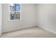 Relaxing bedroom featuring carpet, white walls, and a large window at 791 Washington St, Fuquay Varina, NC 27526