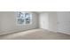 Cozy bedroom featuring neutral carpet, white walls, and large windows at 791 Washington St, Fuquay Varina, NC 27526