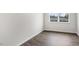Empty room features wood-look flooring, a window, and neutral walls at 791 Washington St, Fuquay Varina, NC 27526