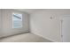 Small bedroom with natural light, neutral carpet, and white walls at 791 Washington St, Fuquay Varina, NC 27526
