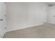 Bright bedroom featuring neutral carpet, white walls, and an open doorway at 791 Washington St, Fuquay Varina, NC 27526