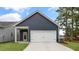 New construction home with a blue exterior, white garage door, and well-manicured lawn at 791 Washington St, Fuquay Varina, NC 27526