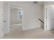 Hallway featuring carpet, white walls, and natural light at 791 Washington St, Fuquay Varina, NC 27526