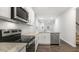 Modern kitchen featuring stainless steel appliances, granite countertops, and white cabinets at 791 Washington St, Fuquay Varina, NC 27526
