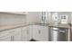 Well-equipped kitchen with stainless steel dishwasher, granite counters, and white cabinets at 791 Washington St, Fuquay Varina, NC 27526
