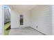 Back patio features white horizontal siding, concrete floors, and a door at 802 Dorset Stream Dr, Fuquay Varina, NC 27526